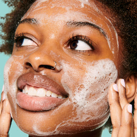 women using face wash to clean dry skin 