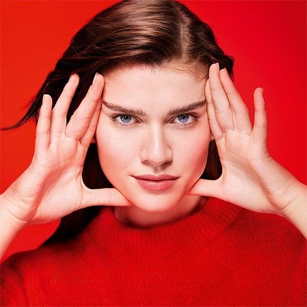 women showcasing the results of anti ageing skincare against a red background 