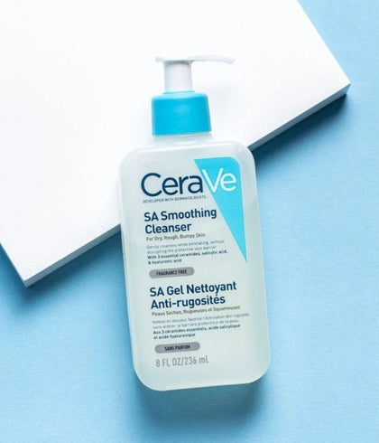 bottle of cerave SA  against a blue and white background 