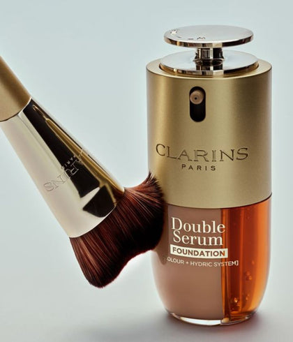 Clarins Double Serum Foundation alongside Clarins foundation brush