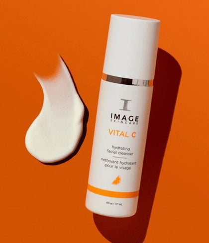 image vital c bottle against an orange background