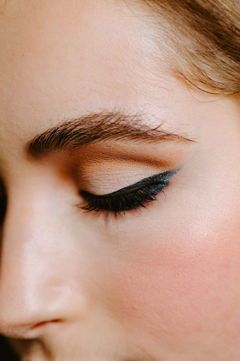 Woman showcasing a stunning cut crease eyeshadow look with black mascara