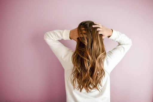  woman running her hands through her hair.
