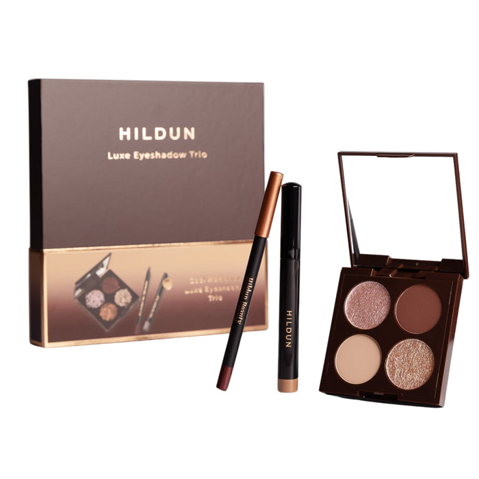 Hildun Luxe Eyeshadow Trio makeup set with a brown and gold box, a black and rose gold pencil, a black and rose gold brow pen, and an open four-color eyeshadow palette on a white background.
