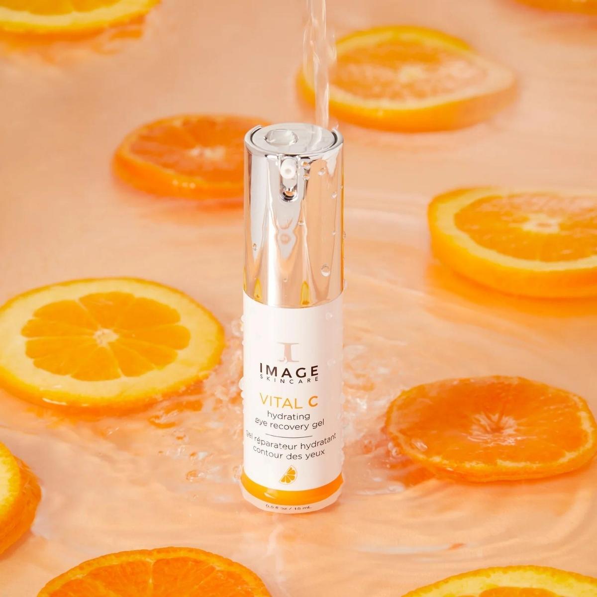 IMAGE Skincare Vital C Hydrating Eye Recovery Gel lifestyle with orange.  